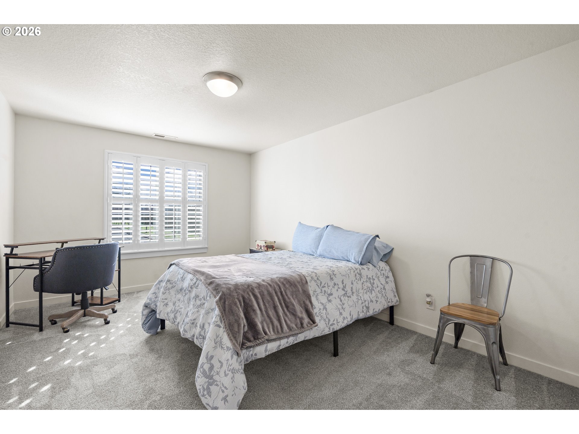 1018 Taurus Loop Northeast Keizer, OR 97303 - Photo 32 of 47 a bedroom with a bed chairs and a window
