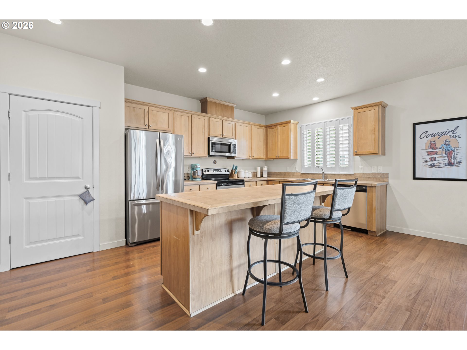 1018 Taurus Loop Northeast Keizer, OR 97303 - Photo 5 of 47 a kitchen with stainless steel appliances a refrigerator a stove a sink dishwasher with a dining table and chairs