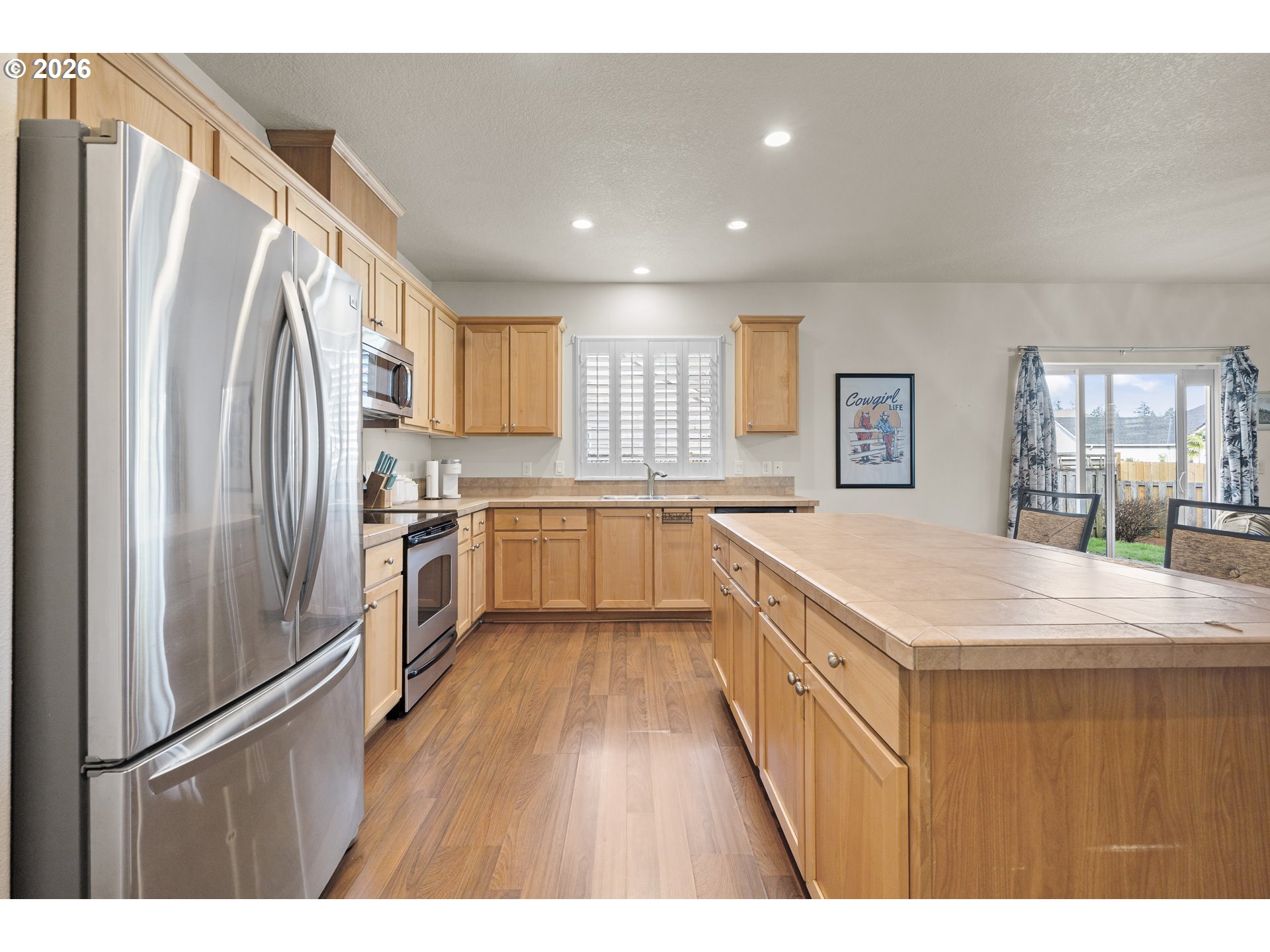 1018 Taurus Loop Northeast Keizer, OR 97303 - Photo 6 of 47 a kitchen with stainless steel appliances granite countertop a refrigerator a sink dishwasher a stove with wooden cabinets