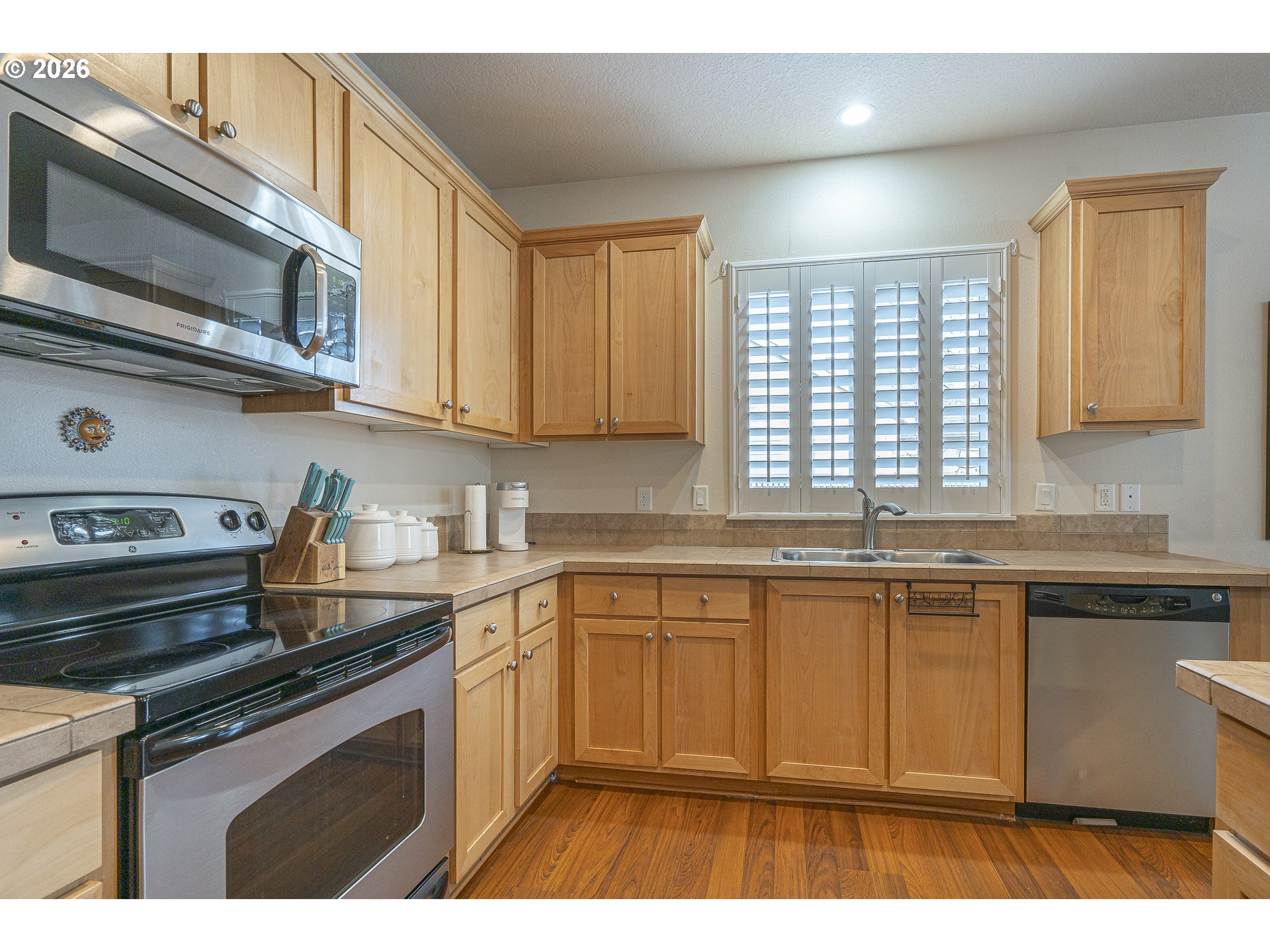 1018 Taurus Loop Northeast Keizer, OR 97303 - Photo 8 of 47 a kitchen with stainless steel appliances granite countertop a stove a sink and a microwave
