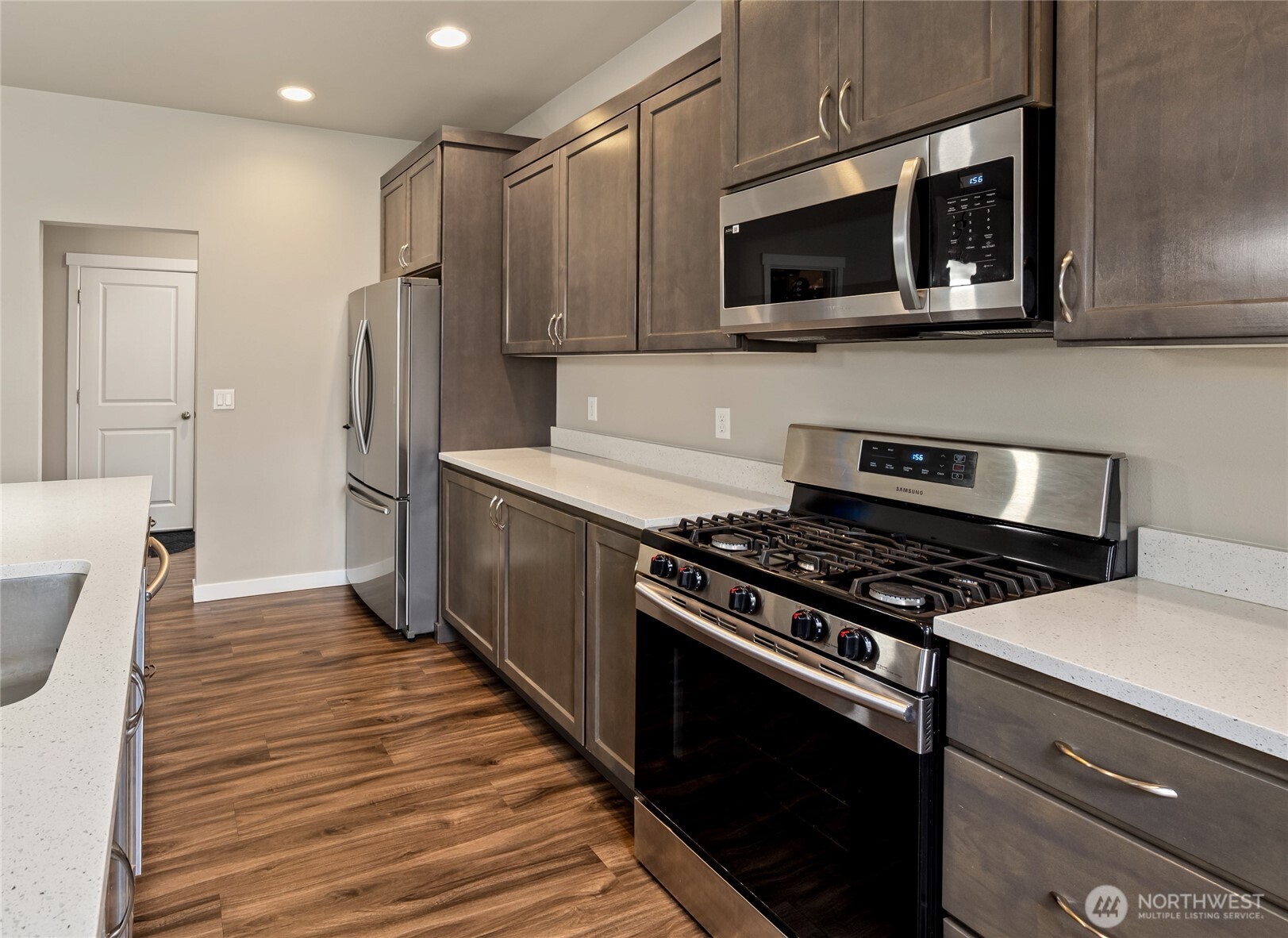 711 10th Street Sultan, WA 98294 - Photo 12 of 30 a kitchen with stainless steel appliances a stove a microwave and cabinets