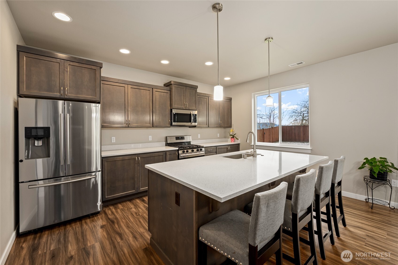 711 10th Street Sultan, WA 98294 - Photo 13 of 30 a kitchen with kitchen island a counter space a sink refrigerator and dining table
