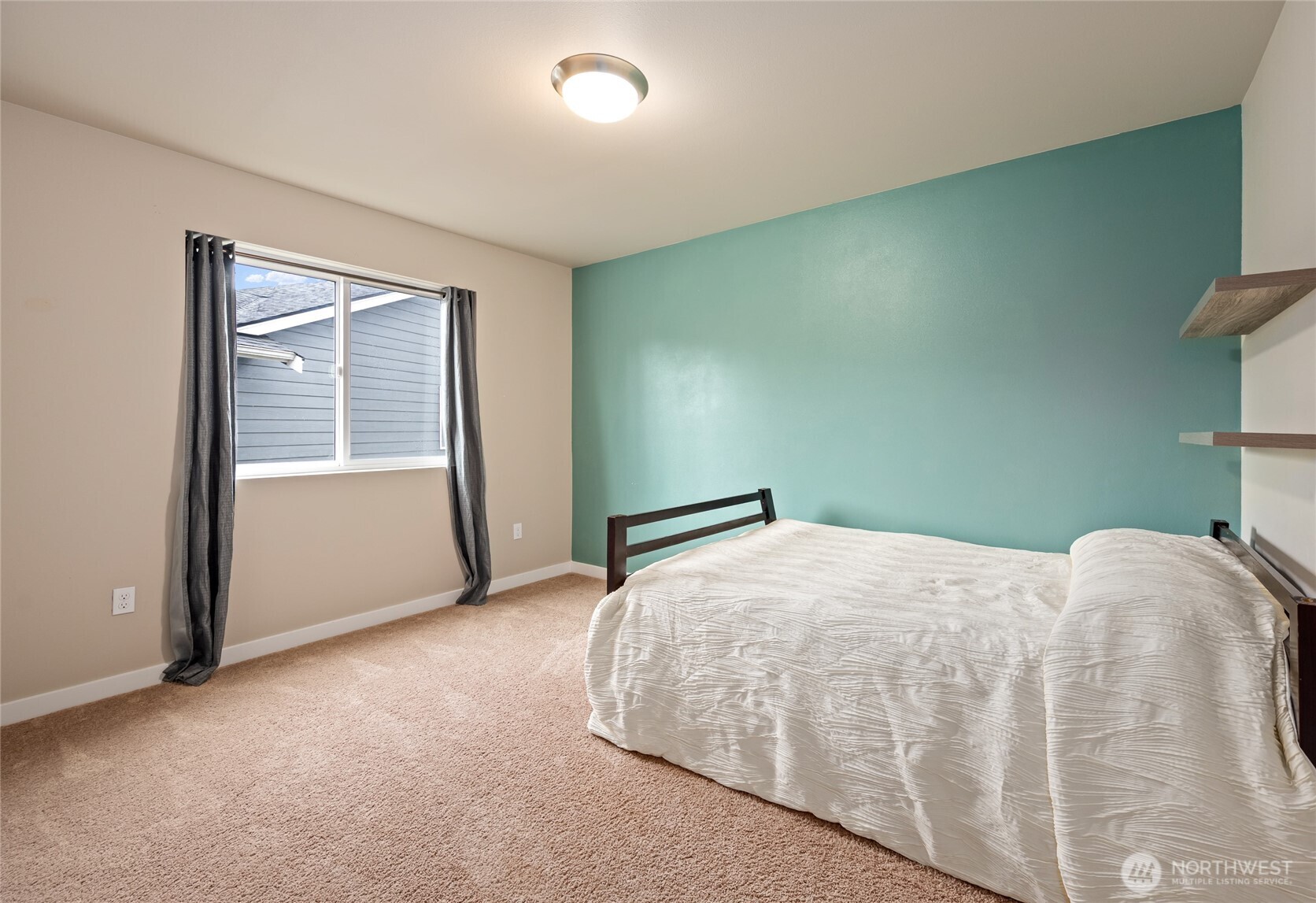 711 10th Street Sultan, WA 98294 - Photo 25 of 30 a bedroom with a bed and a window