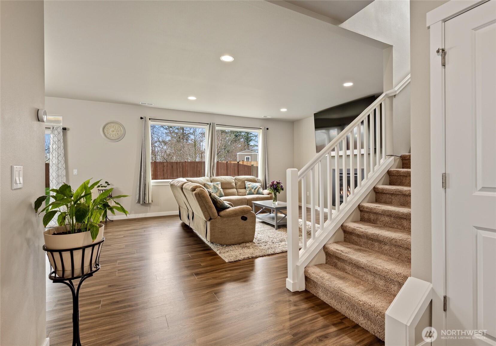 711 10th Street Sultan, WA 98294 - Photo 5 of 30 a living room with furniture floor to ceiling windows and a potted plant
