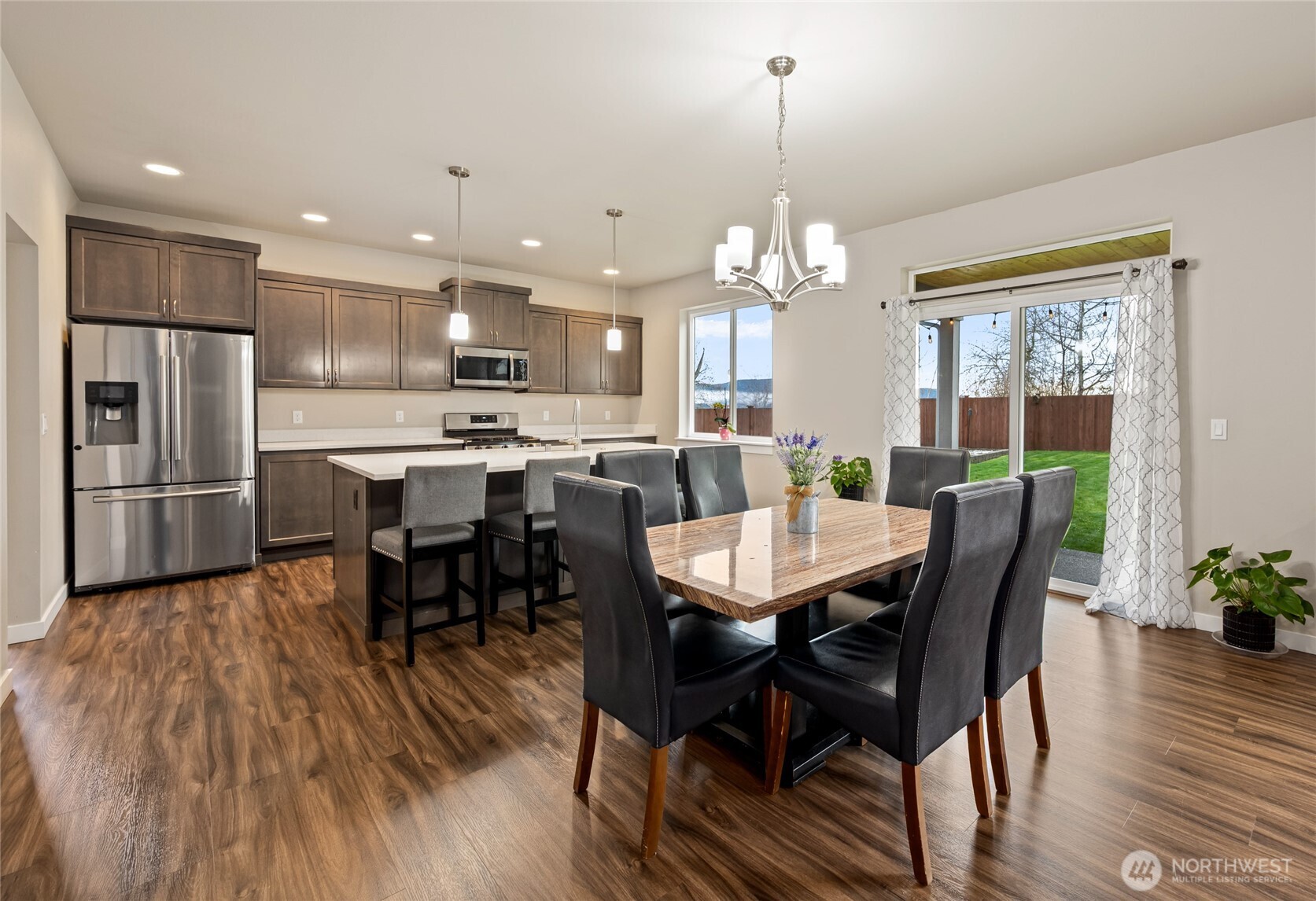 711 10th Street Sultan, WA 98294 - Photo 9 of 30 a view of a dining room and livingroom with furniture wooden floor a chandelier