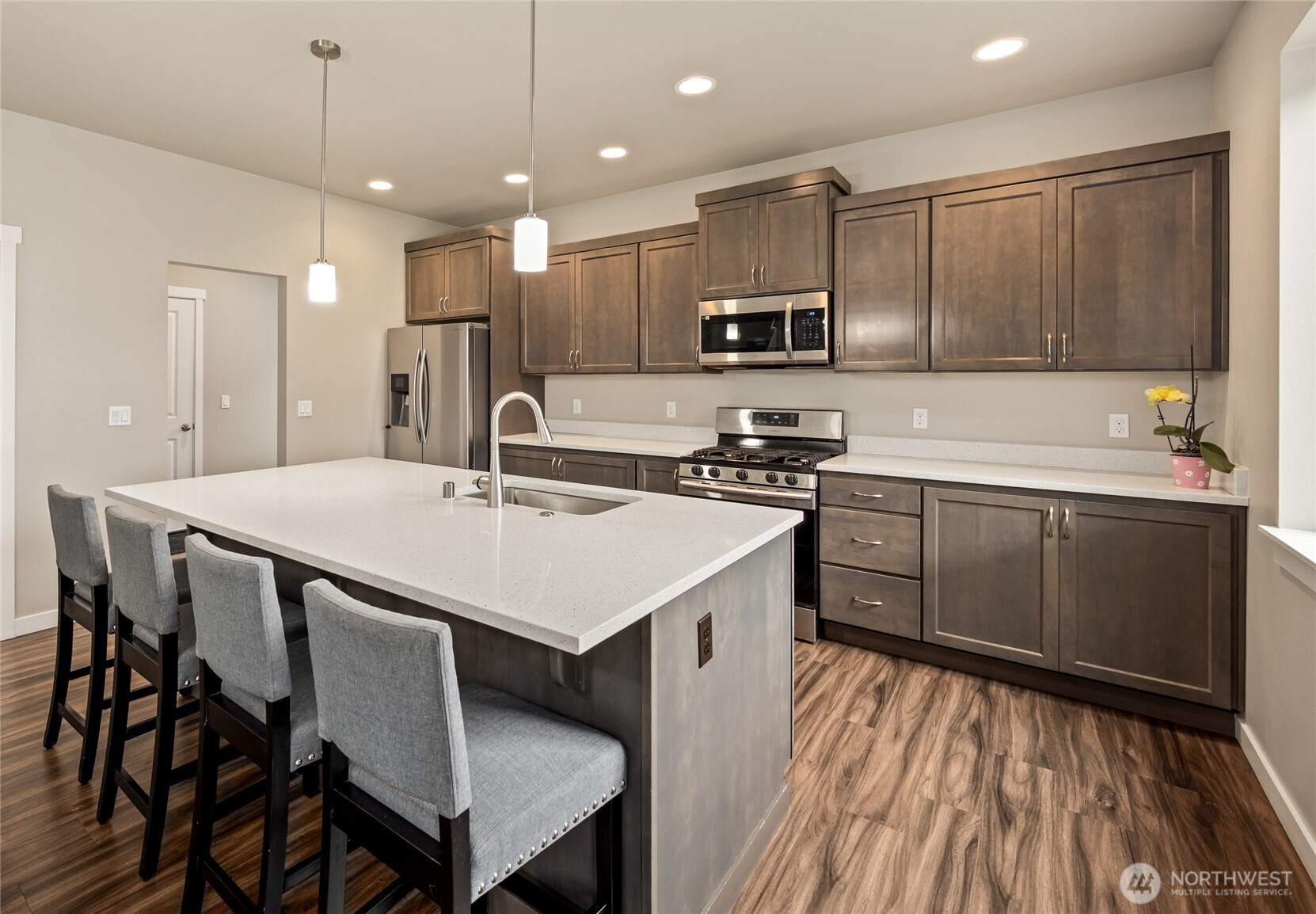 711 10th Street Sultan, WA 98294 - Photo 10 of 30 a kitchen with a sink a counter top space stainless steel appliances and cabinets