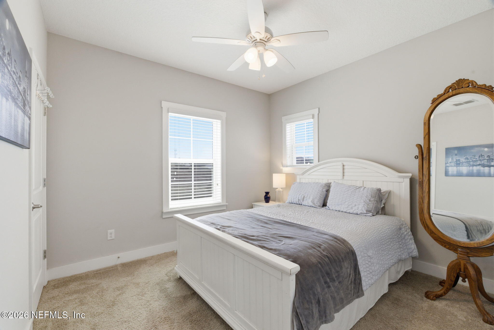 44 Fremont Avenue St. Augustine, FL 32095 - Photo 30 of 72 a bedroom with a bed a chandelier and a window
