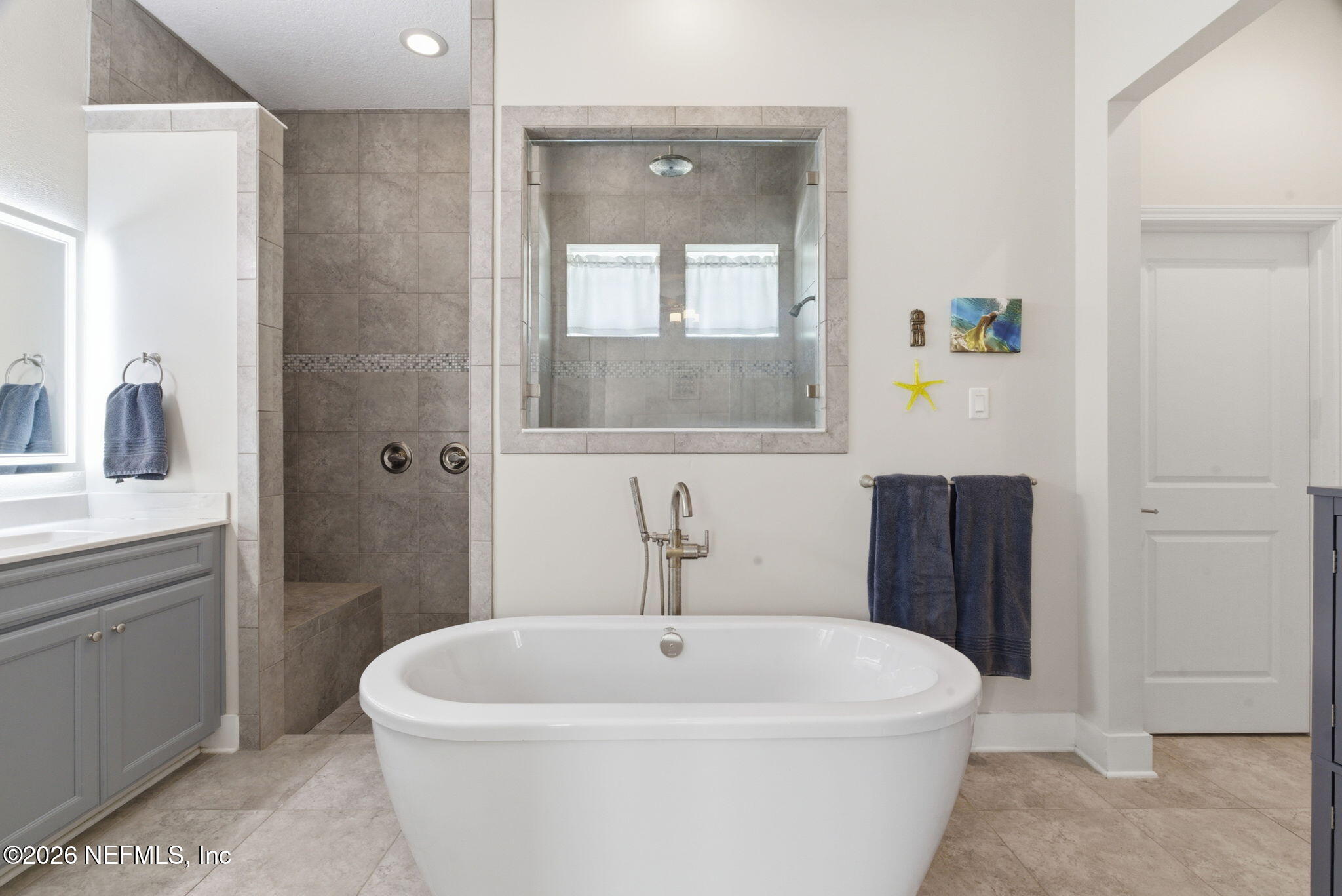 44 Fremont Avenue St. Augustine, FL 32095 - Photo 5 of 72 a white bath tub sitting next to a white sink and mirror