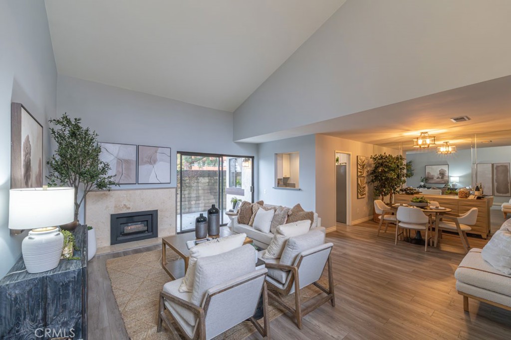 5002 East Atherton Street Long Beach, CA 90815 - Photo 1 of 52 a living room with furniture fireplace and a large window