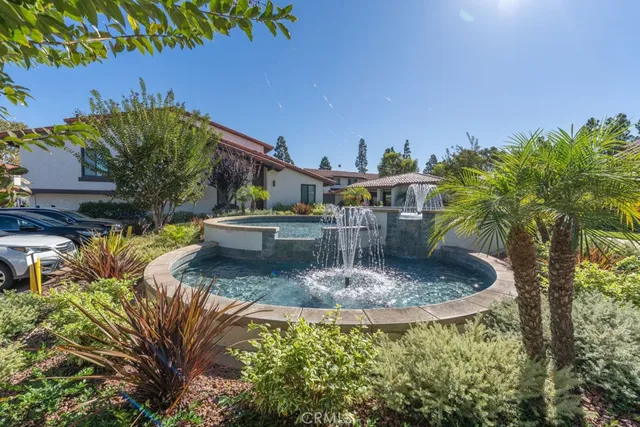 a view of a water fountain in front of house