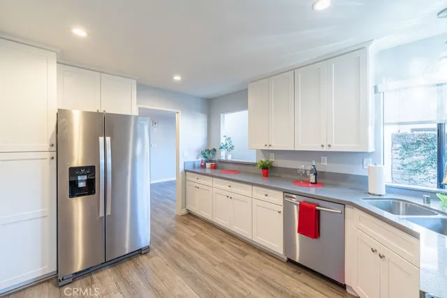 a kitchen with stainless steel appliances granite countertop a refrigerator sink and cabinets