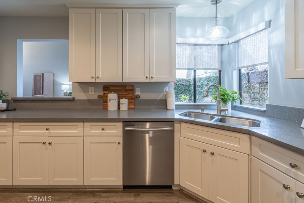 5002 East Atherton Street Long Beach, CA 90815 - Photo 14 of 52 a kitchen with white cabinets and white appliances
