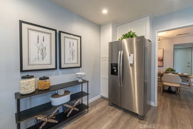 a kitchen with stainless steel appliances granite countertop a refrigerator and a stove top oven