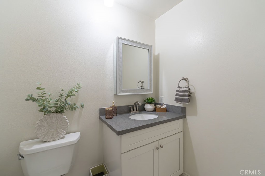 5002 East Atherton Street Long Beach, CA 90815 - Photo 21 of 52 a bathroom with a toilet sink and mirror