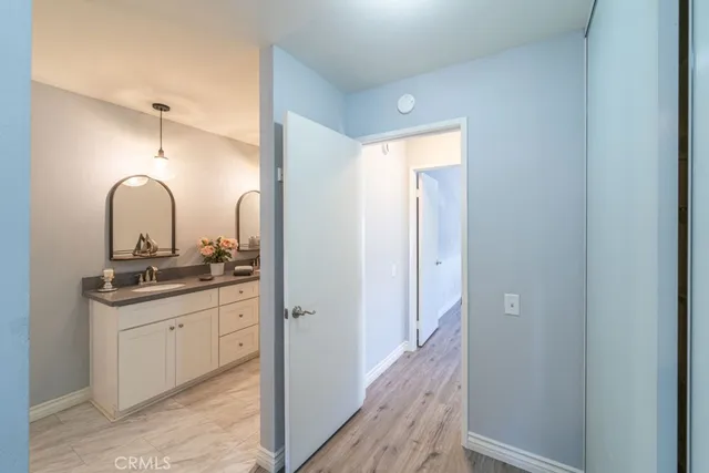 a bathroom with a double vanity sink and mirror with shower
