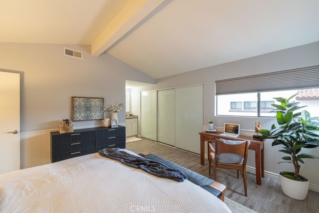 5002 East Atherton Street Long Beach, CA 90815 - Photo 25 of 52 a bedroom with a bed and a potted plant