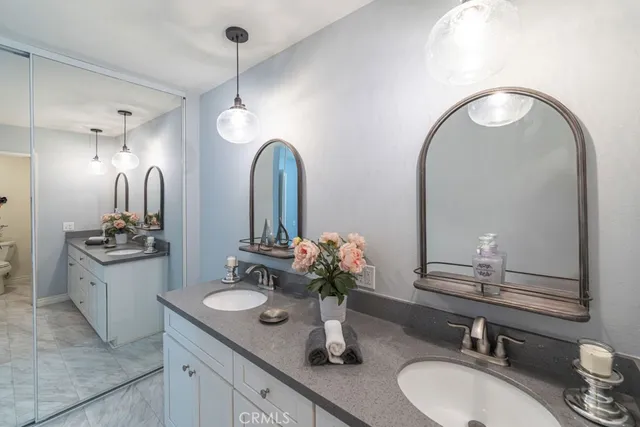 a bathroom with double vanity sinks and a mirror