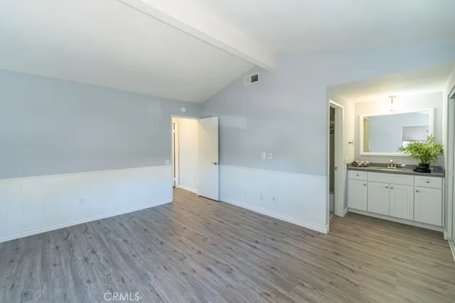 a view of a kitchen with wooden floor and a sink