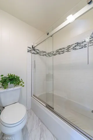 a bathroom with a toilet and a shower