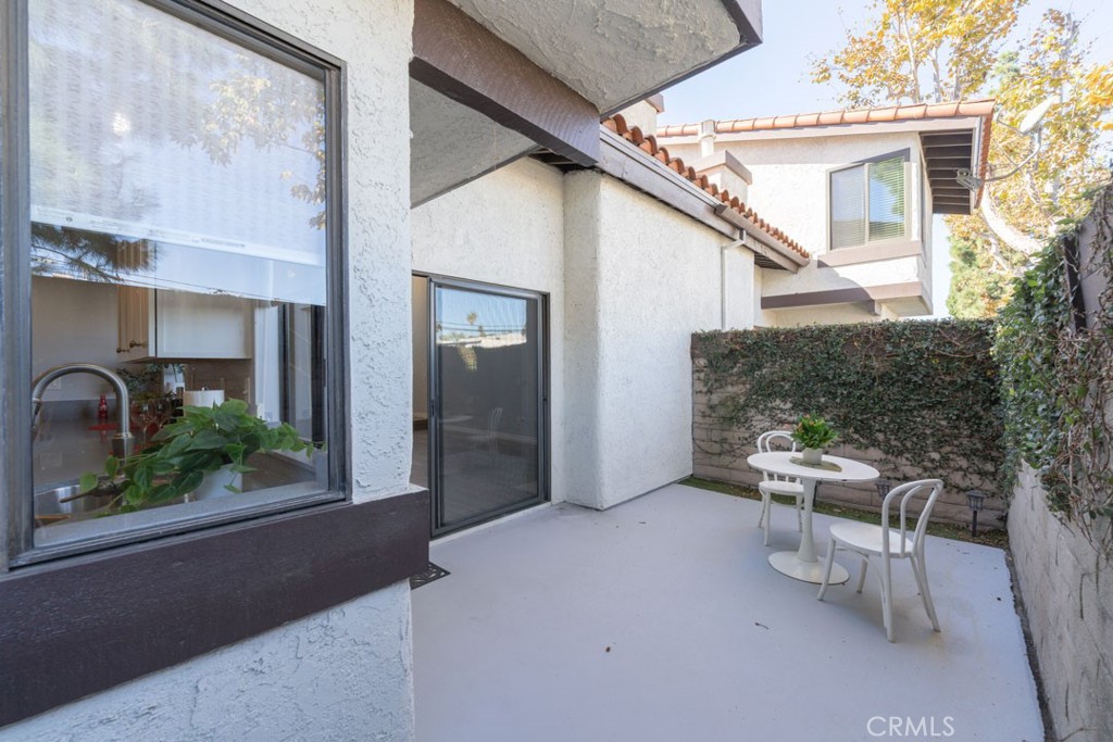 5002 East Atherton Street Long Beach, CA 90815 - Photo 42 of 52 a view of a patio with table and chairs and potted plants