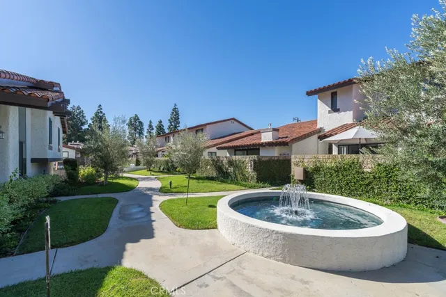 a view of a water fountain in front of a house
