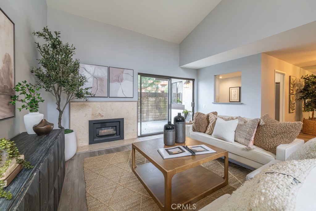 5002 East Atherton Street Long Beach, CA 90815 - Photo 7 of 52 a living room with furniture and a fireplace