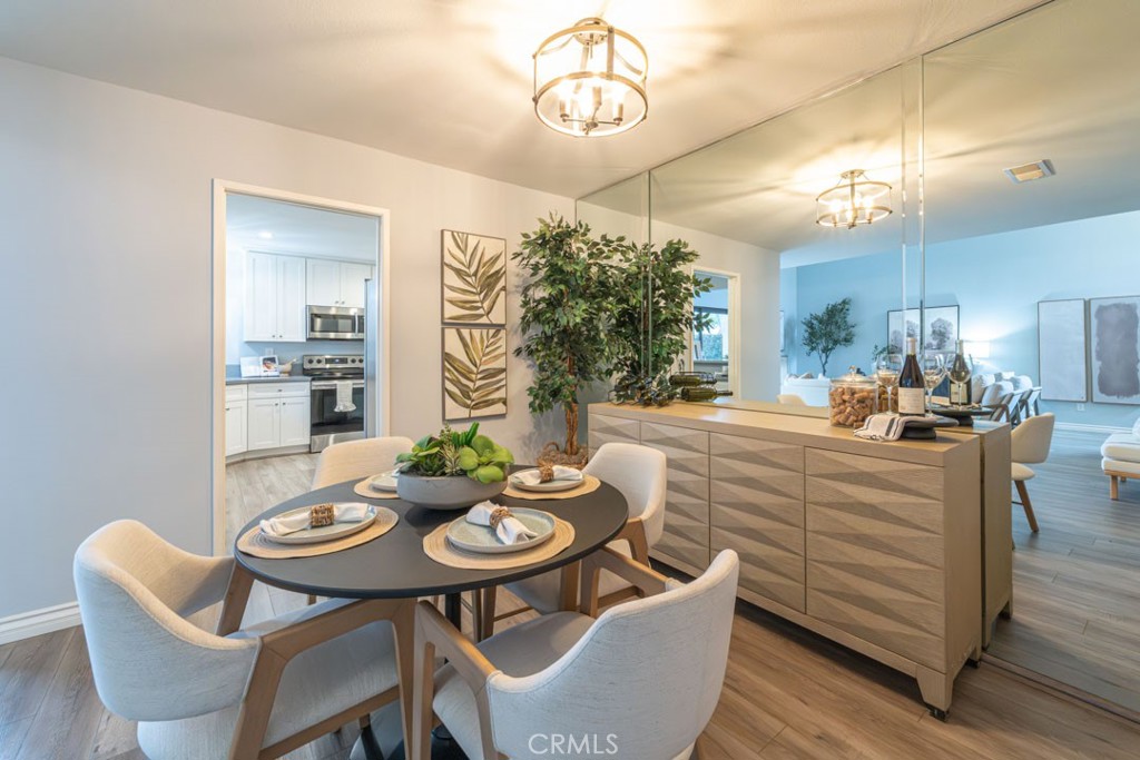 5002 East Atherton Street Long Beach, CA 90815 - Photo 9 of 52 a kitchen with a table chairs stove and living room view