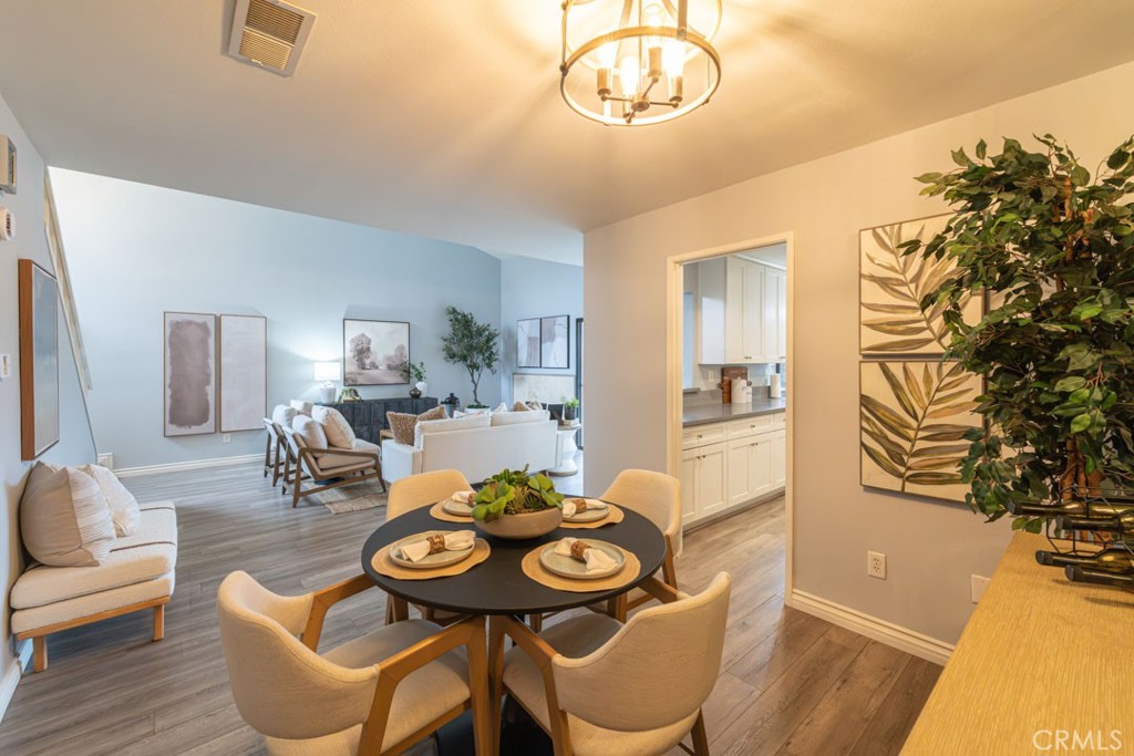 5002 East Atherton Street Long Beach, CA 90815 - Photo 10 of 52 a view of a dining room with furniture and a chandelier