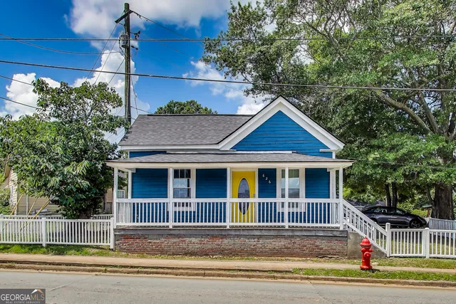 a view of house and tree in front of it