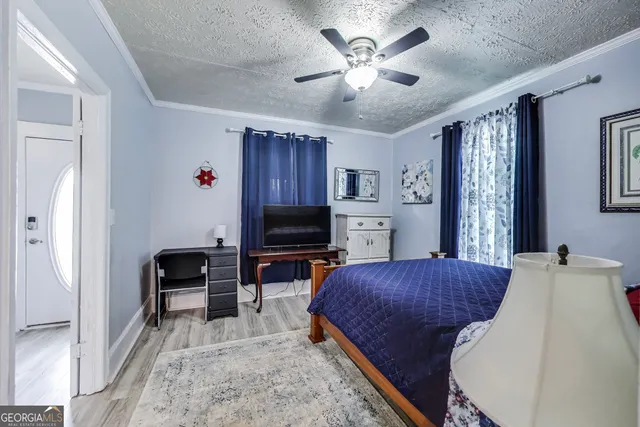 a bedroom with furniture and a flat screen tv