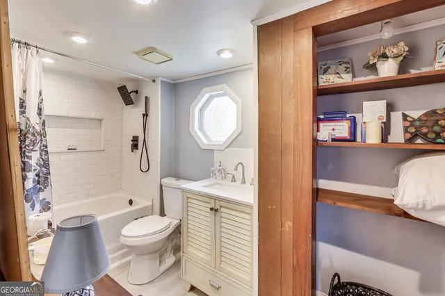 a bathroom with a toilet a sink and a shower