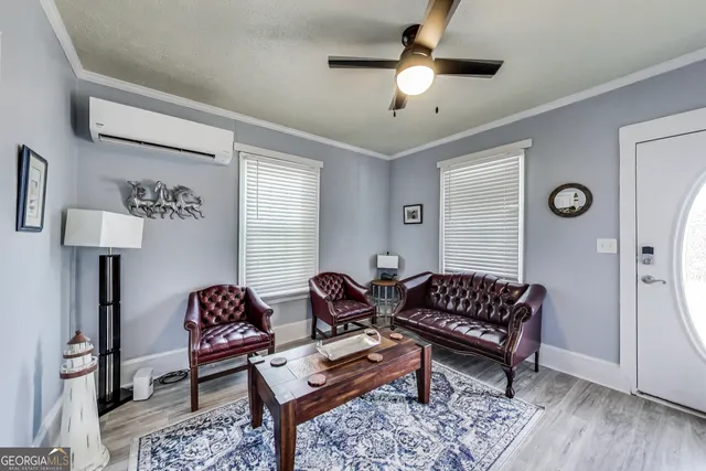 a living room with furniture and a chandelier