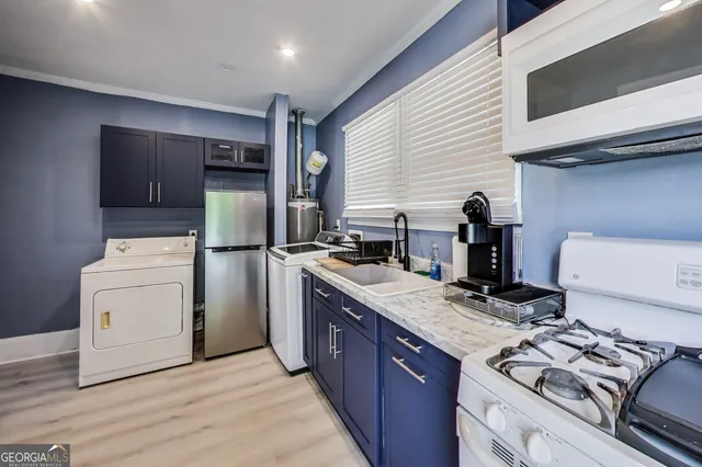a kitchen with a stove and a refrigerator