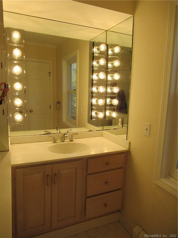11 Burnt Swamp Road Woodbridge, CT 06525 - Photo 18 of 29 a bathroom with a sink and a mirror
