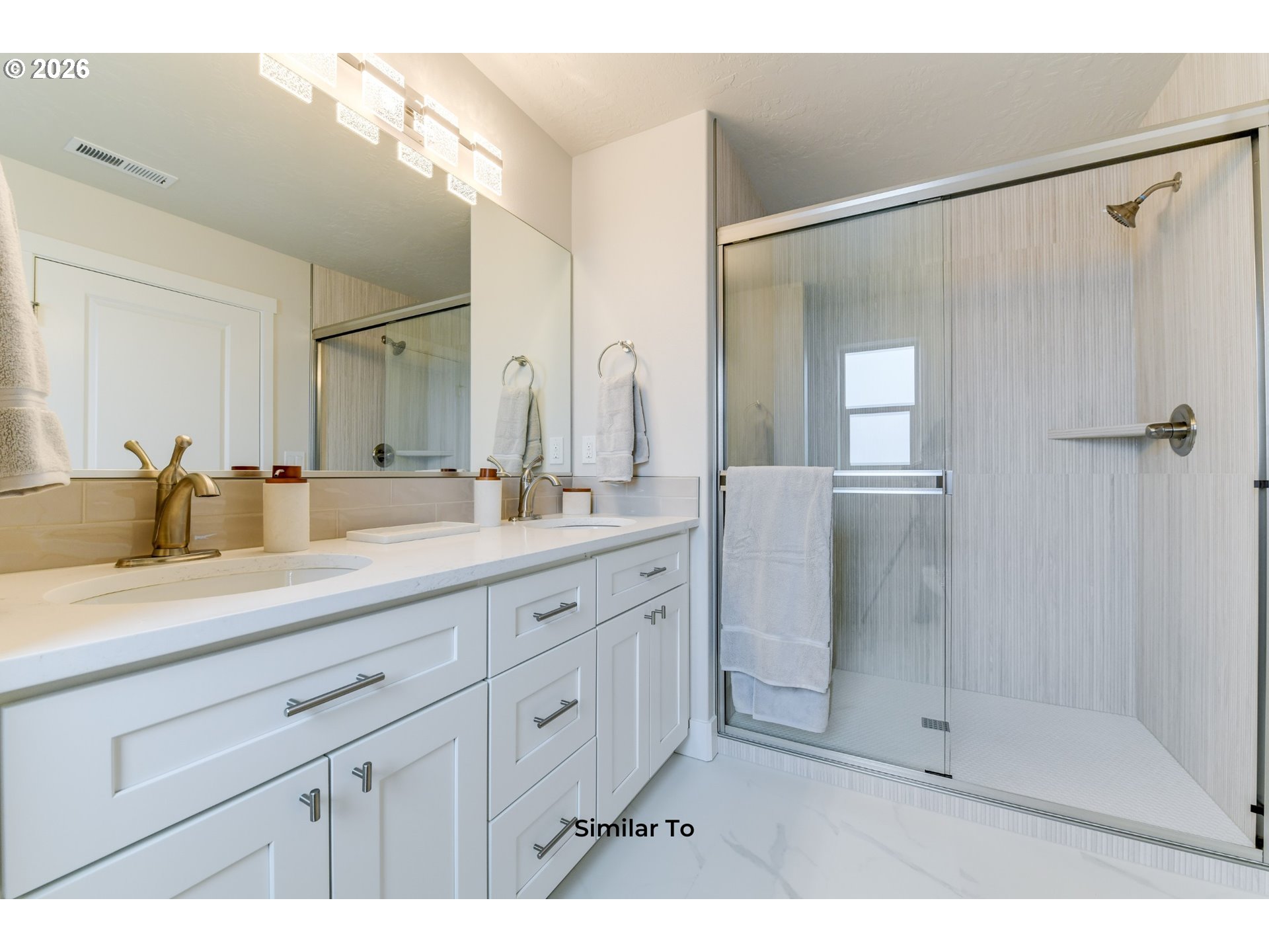 227 Southwest Goldfinch Lane Boardman, OR 97818 - Photo 19 of 28 a bathroom with a double vanity sink mirror and shower