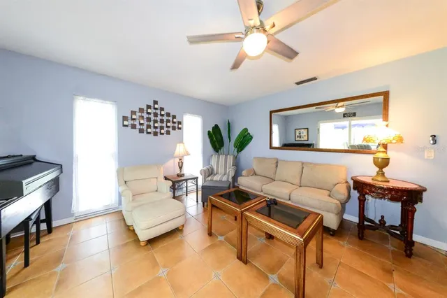 a living room with furniture and a lamp