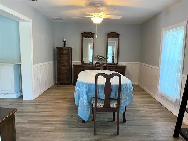 a bedroom with furniture and a wooden floor