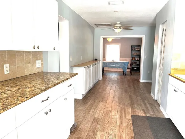 an aerial view of residential house with outdoor space and trees all around