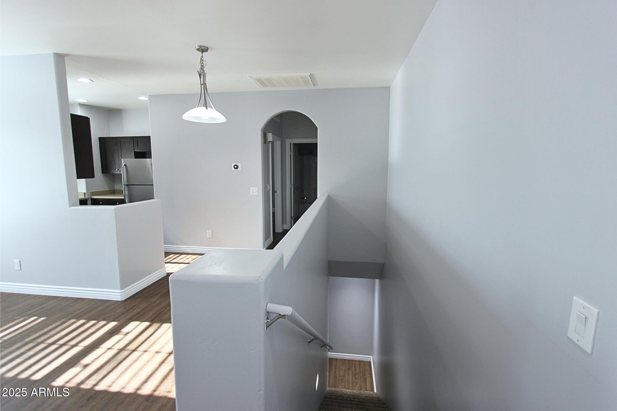 854 South San Marcos Drive, Unit A4 Apache Junction, AZ 85120 - Photo 12 of 22 a view of a livingroom with wooden floor and staircase