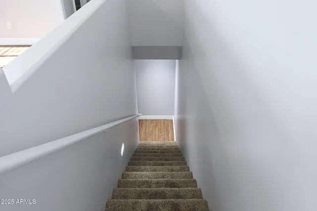 a view of a hallway with stairs