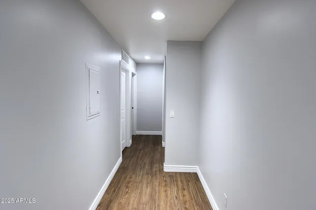 a view of a hallway with wooden floor