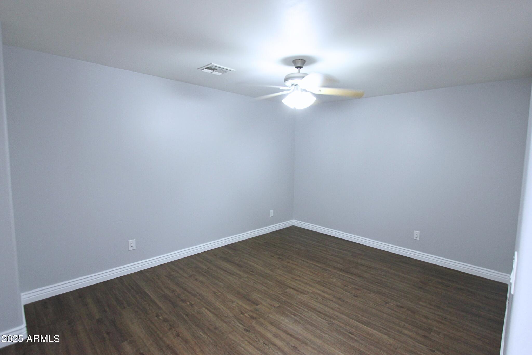 854 South San Marcos Drive, Unit A4 Apache Junction, AZ 85120 - Photo 15 of 22 a view of an empty room with wooden floor