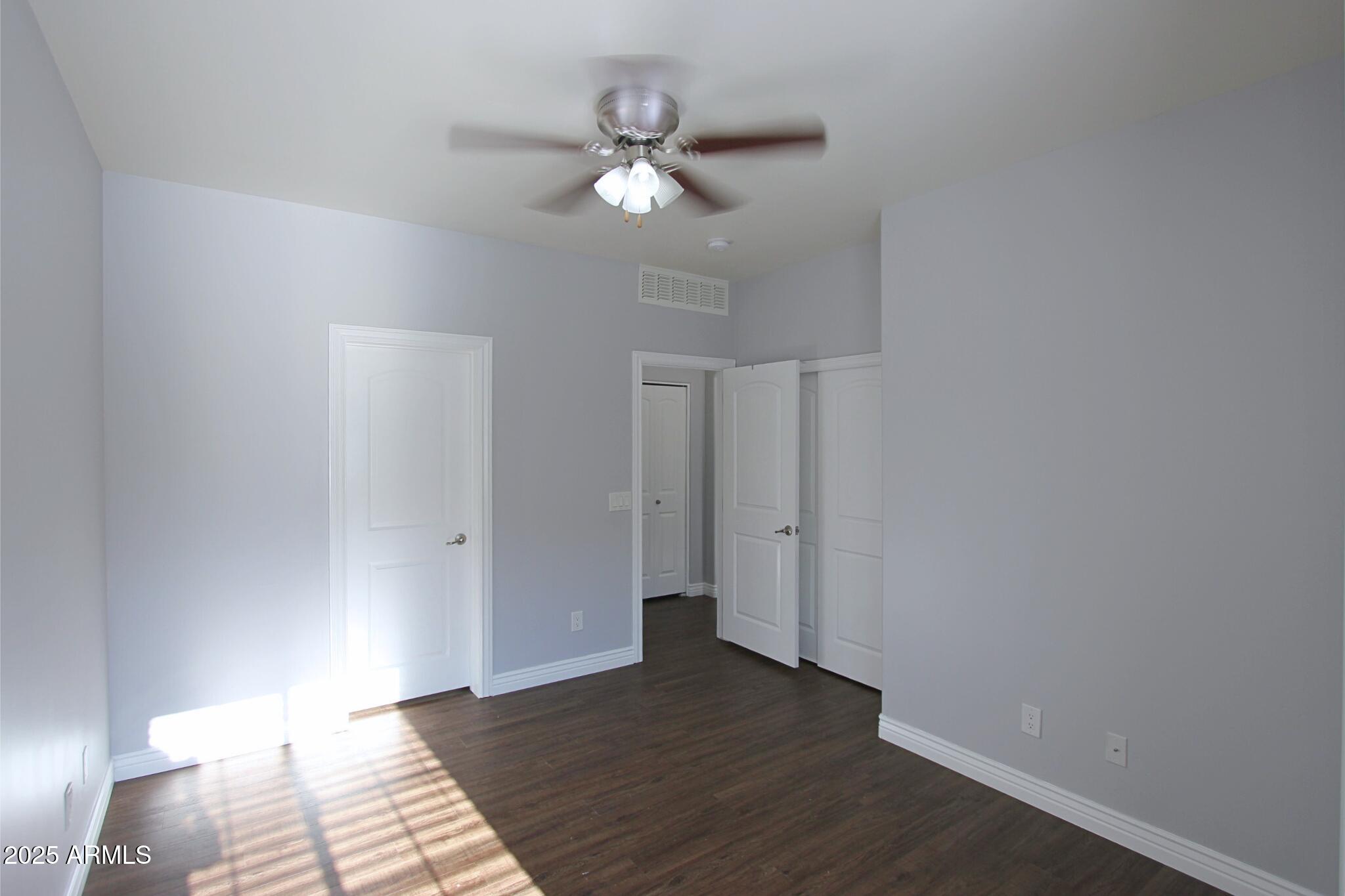 854 South San Marcos Drive, Unit A4 Apache Junction, AZ 85120 - Photo 18 of 22 a view of an empty room with wooden floor