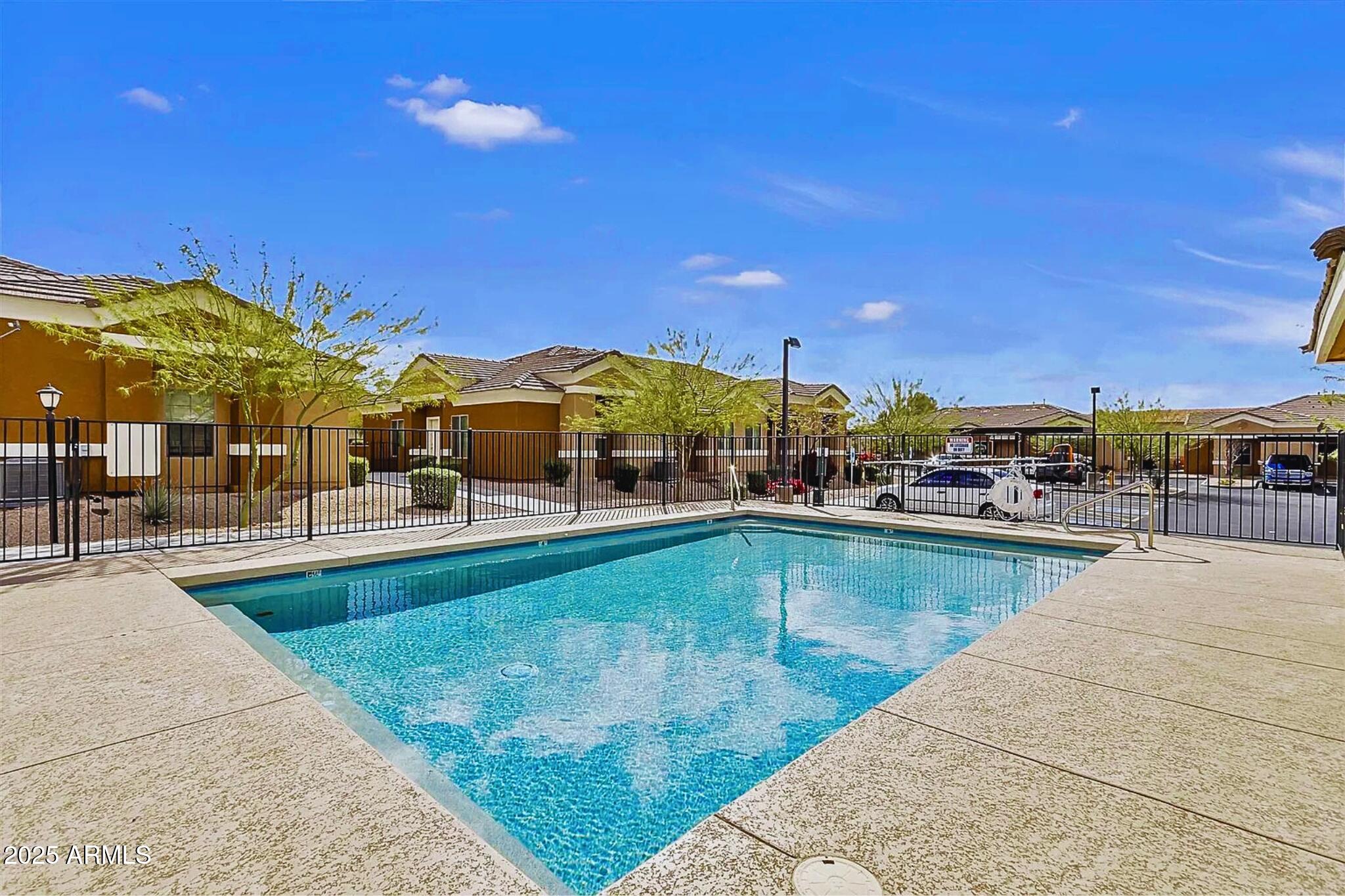 854 South San Marcos Drive, Unit A4 Apache Junction, AZ 85120 - Photo 19 of 22 a view of a swimming pool and lounge chairs