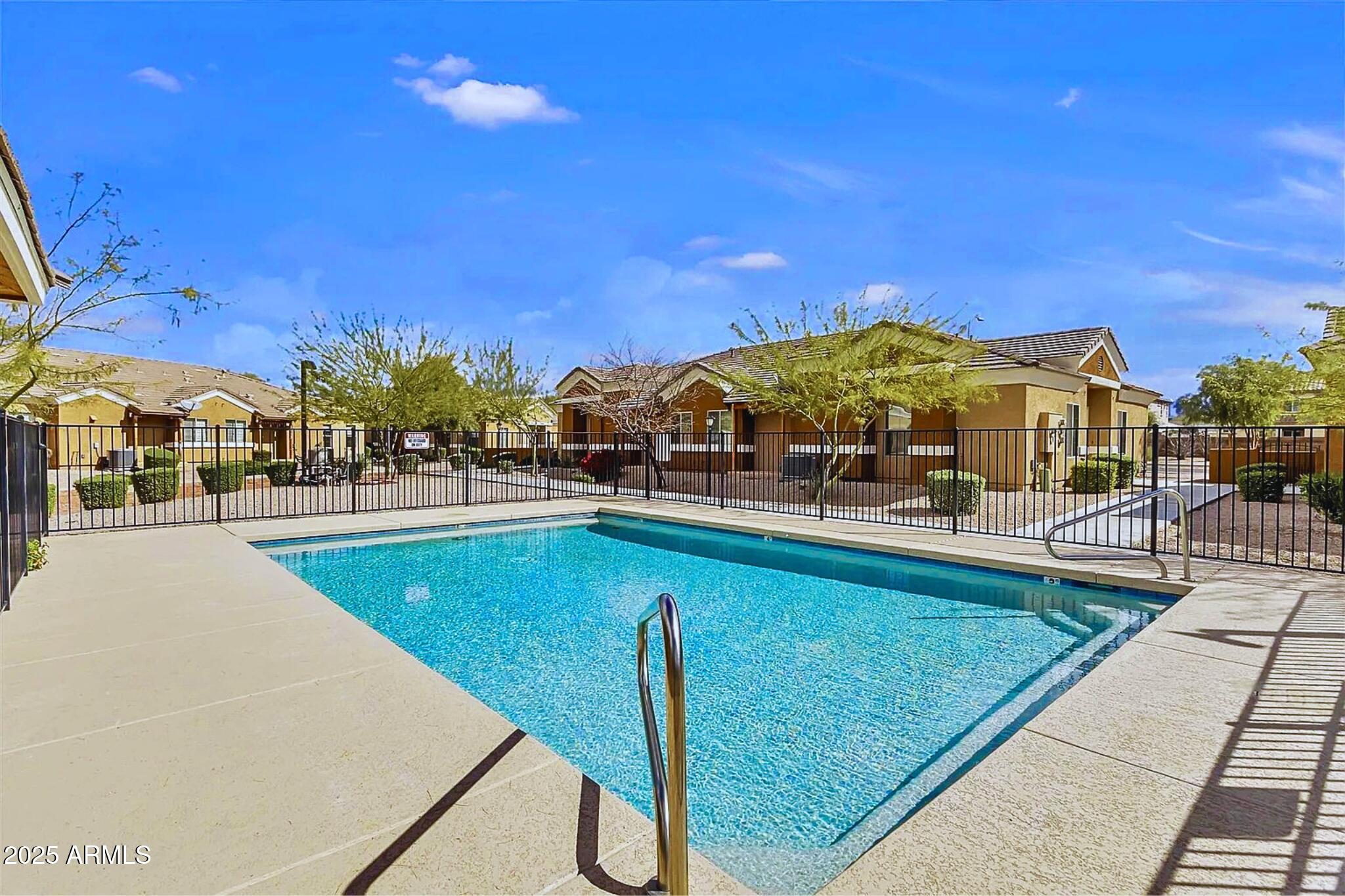 854 South San Marcos Drive, Unit A4 Apache Junction, AZ 85120 - Photo 20 of 22 a view of a swimming pool with a lounge chair