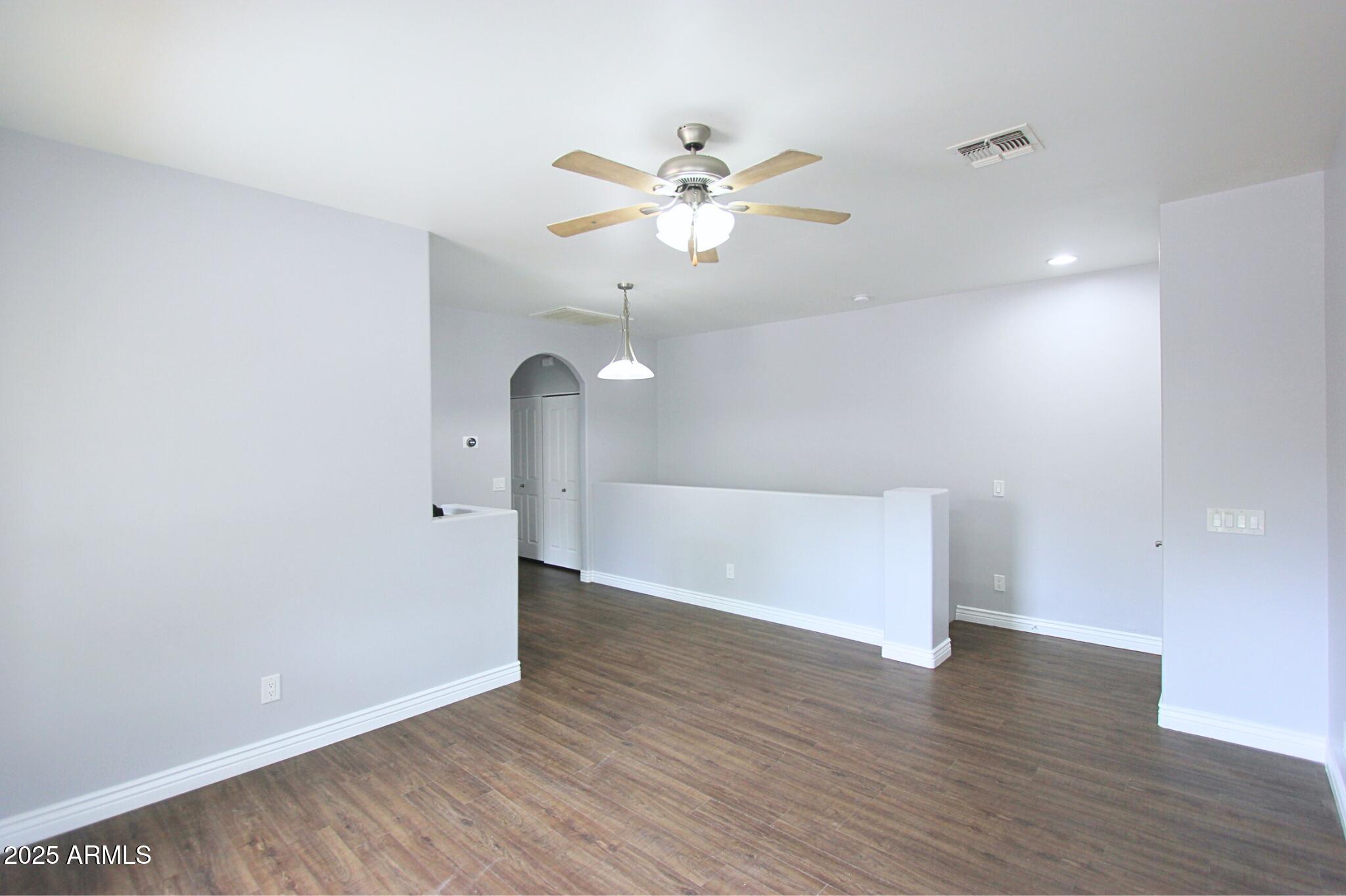 854 South San Marcos Drive, Unit A4 Apache Junction, AZ 85120 - Photo 3 of 22 wooden floor in an empty room with a window