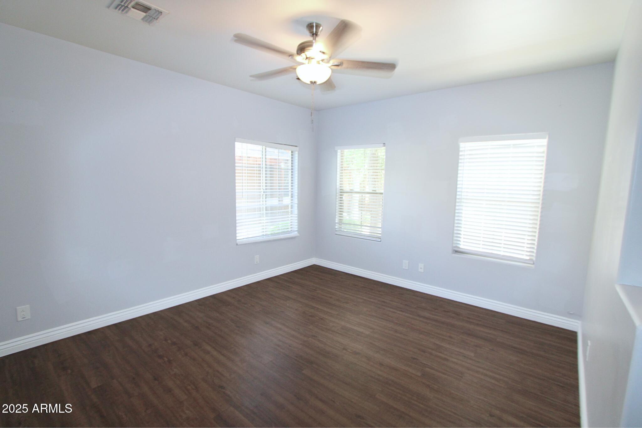 854 South San Marcos Drive, Unit A4 Apache Junction, AZ 85120 - Photo 5 of 22 a view of an empty room with a window and wooden floor