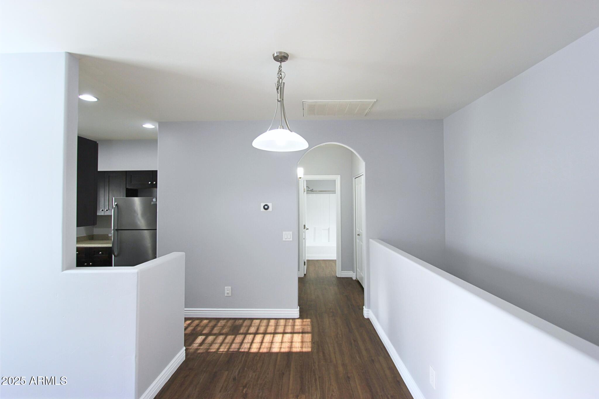 854 South San Marcos Drive, Unit A4 Apache Junction, AZ 85120 - Photo 6 of 22 a view of a hallway with wooden floor and staircase