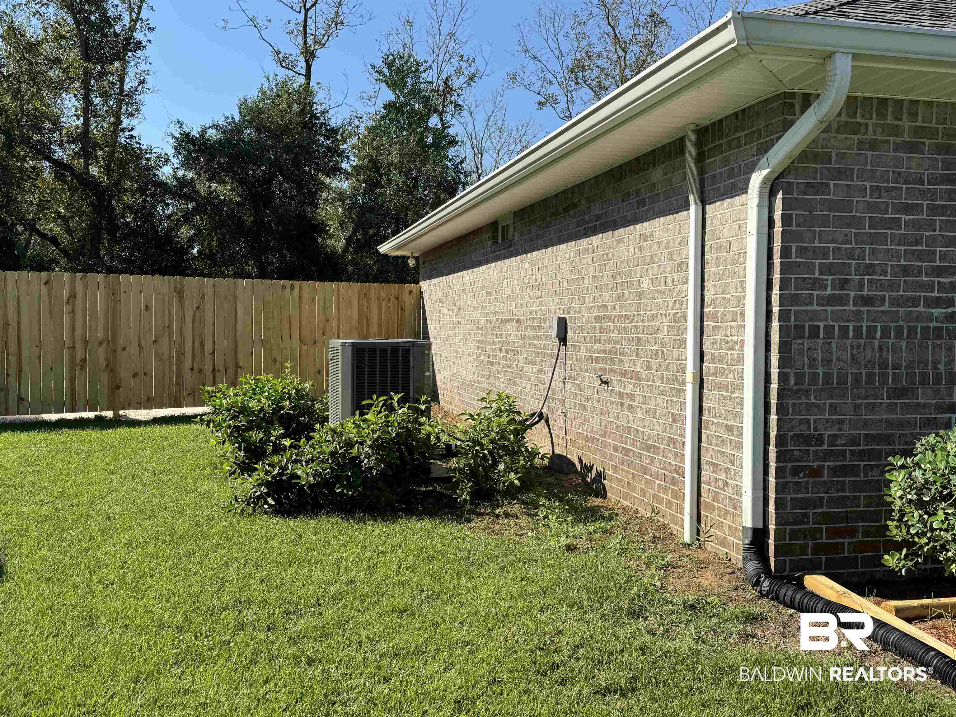32769 Arbor Ridge Circle Lillian, AL 36549 - Photo 28 of 36 View of side of home with cooling unit and a yard