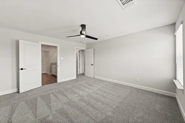 a view of a livingroom with a ceiling fan and window